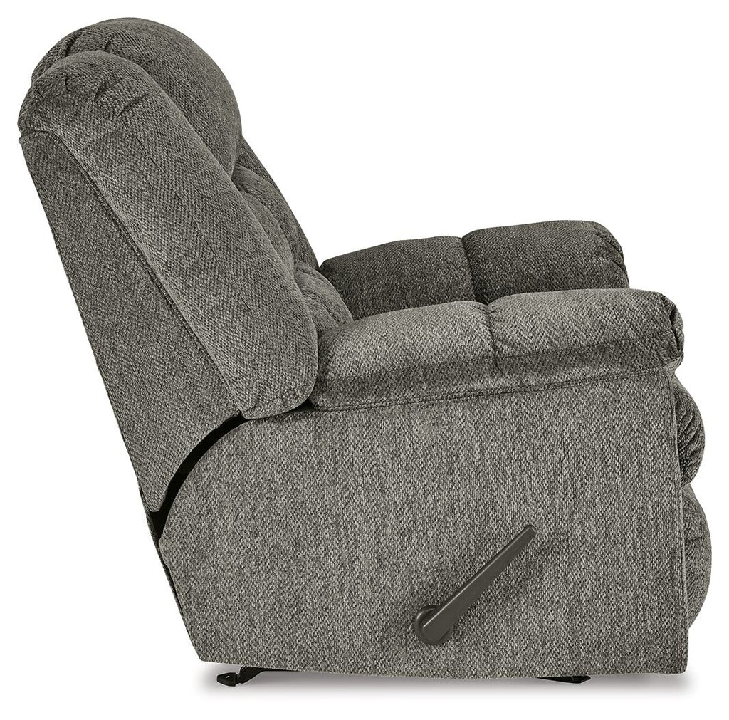Gray rocker recliner chair, angled side view with side control handle and thick armrests