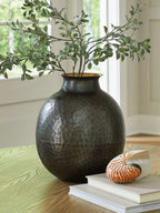Dark gray hammered ceramic vase on table with gold-toned interior rim
