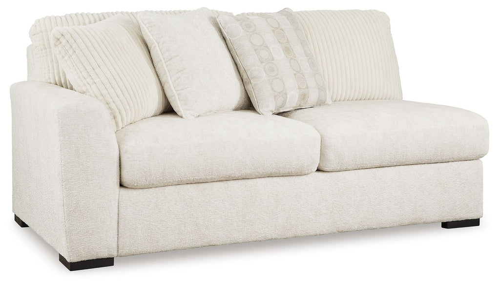 Light ivory fabric sofa with two seat cushions, arched arms, and back pillows