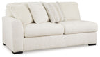 Light ivory fabric sofa with two seat cushions, arched arms, and back pillows
