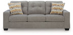 Queen sofa sleeper with gray upholstery and two patterned pillows on back cushions