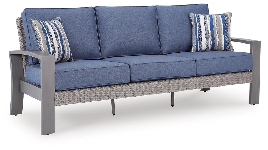 Blue-gray fabric sofa with two striped throw pillows and seat cushions