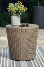 Beige round end table with tall woven wicker sides and round tabletop.