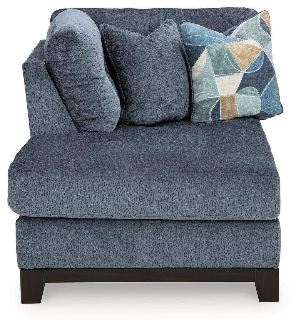 Navy corner chaise sofa with plush chaise seat, tufted back, geometric pillow, dark legs
