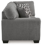 Gray corner wedge sofa chaise with rounded arms and patterned back throw pillow