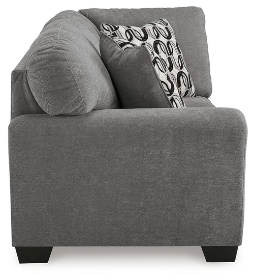Gray corner wedge sofa chaise with rounded arms and patterned back throw pillow