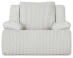Light rocker recliner chair with ribbed upholstery and two plush side arms