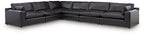Black leather-look sectional sofa with multiple connected chaise sections and back pillows