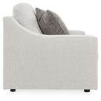 Chalk loveseat side profile with dark gray pillows and boxy armrest