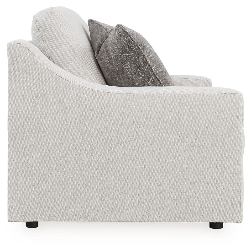 Chalk loveseat side profile with dark gray pillows and boxy armrest