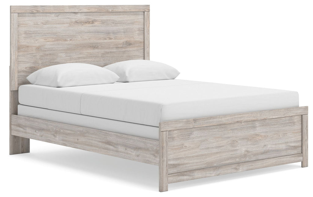 Panel bed frame in light brown woodgrain with white upholstered mattress and two pillows