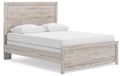 Panel bed frame in light brown woodgrain with white upholstered mattress and two pillows
