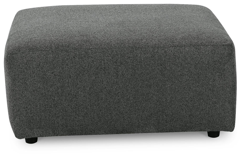 Oversized accent ottoman in dark gray textured fabric with rounded corners