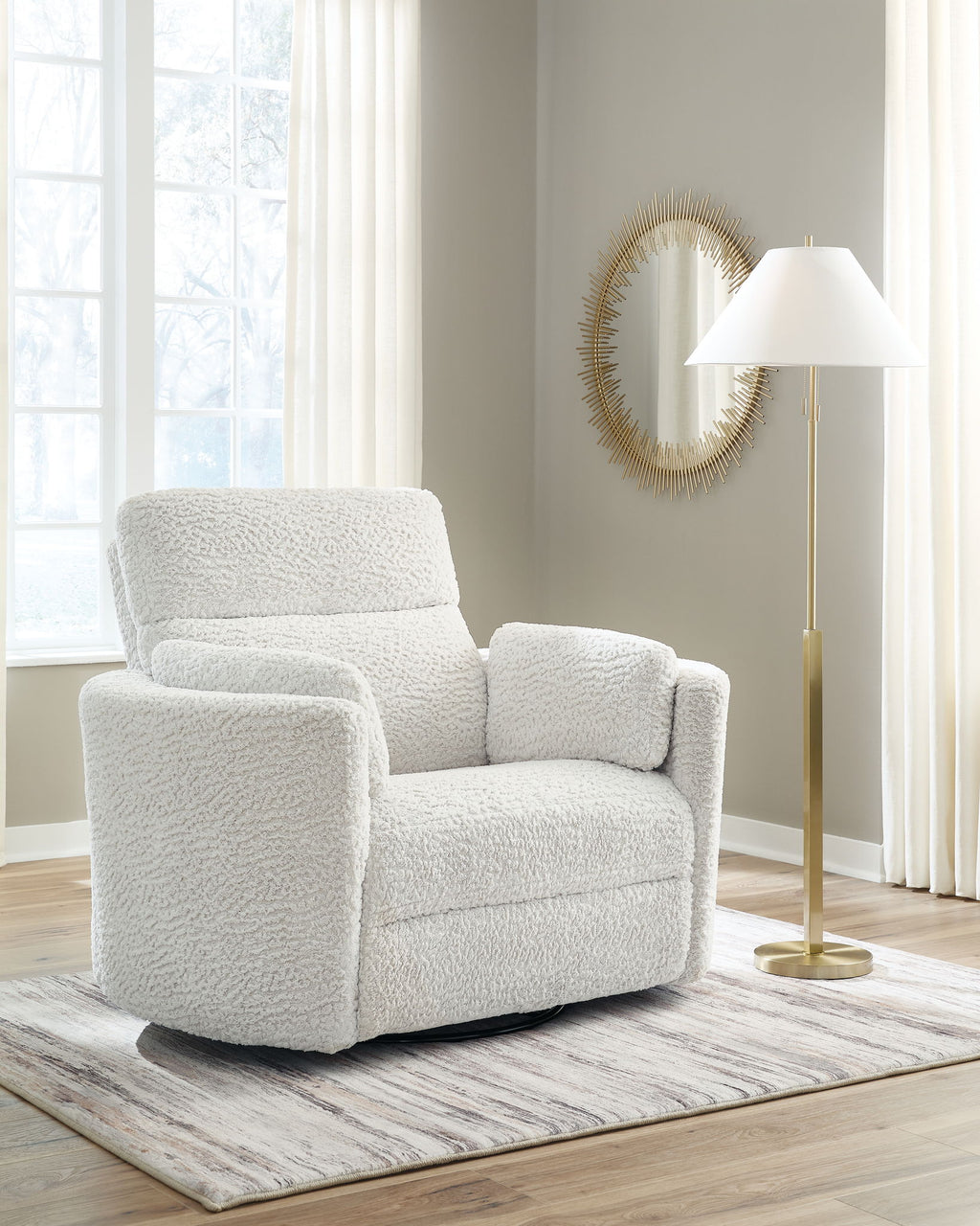 Swivel glider recliner chair in light cream with boxy arms and thick padded seat
