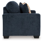 Dark navy loveseat with two decorative geometric throw pillows and boxed front.