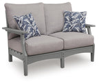 Gray loveseat with seat cushion and two blue floral throw pillows