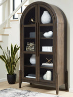 Dark brown accent cabinet with arched doors and open shelving with decor items inside