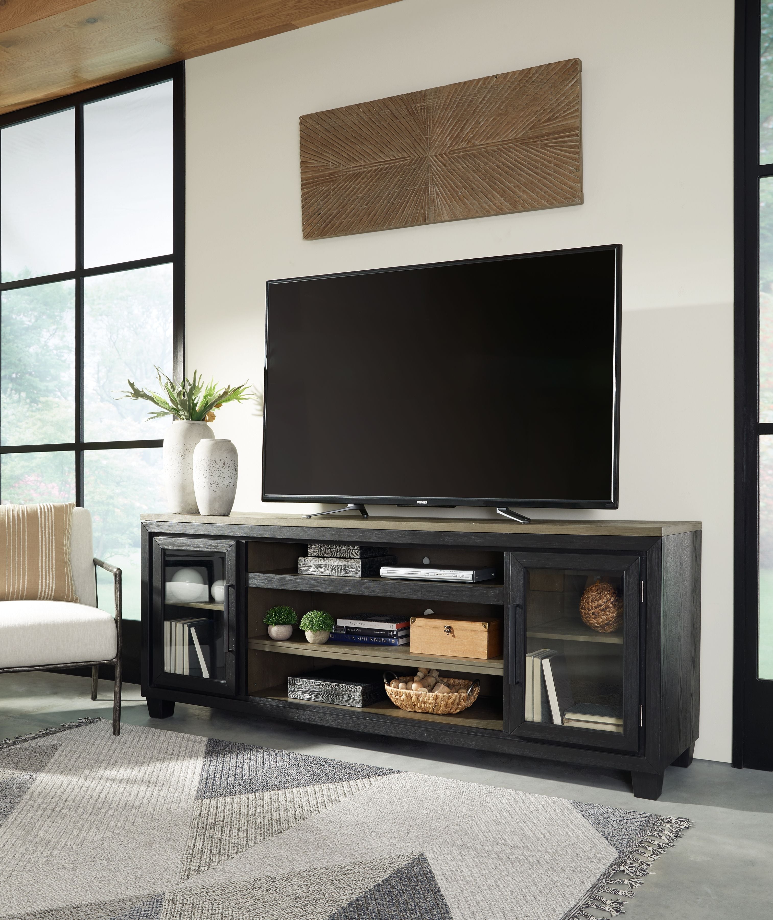 Black TV stand with center shelves and side cabinet doors for media
