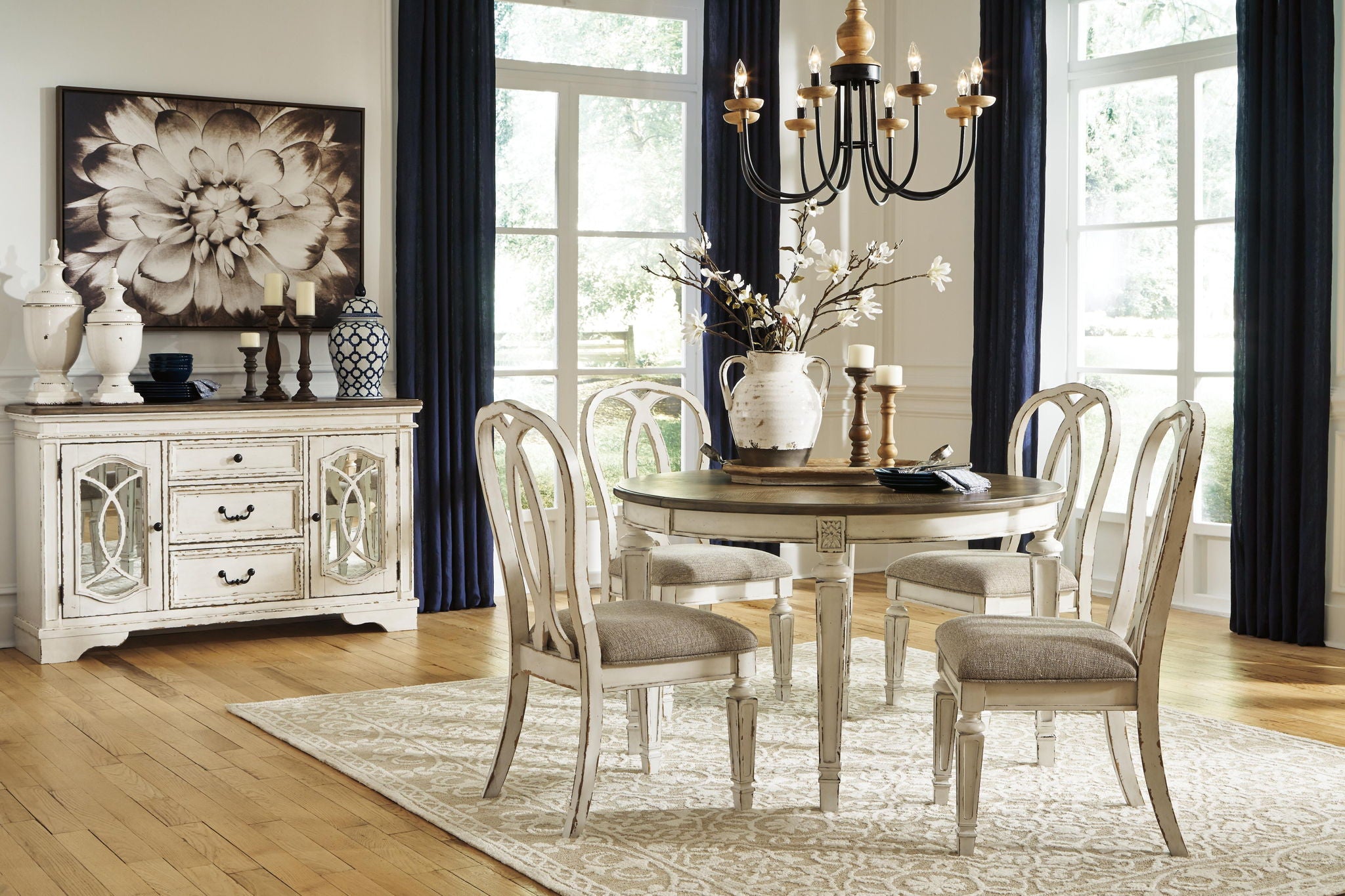 Chipped white oval extension dining table with pedestal base and visible scuffs