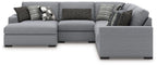 Gray sectional sofa with chaise arm and patterned throw pillows