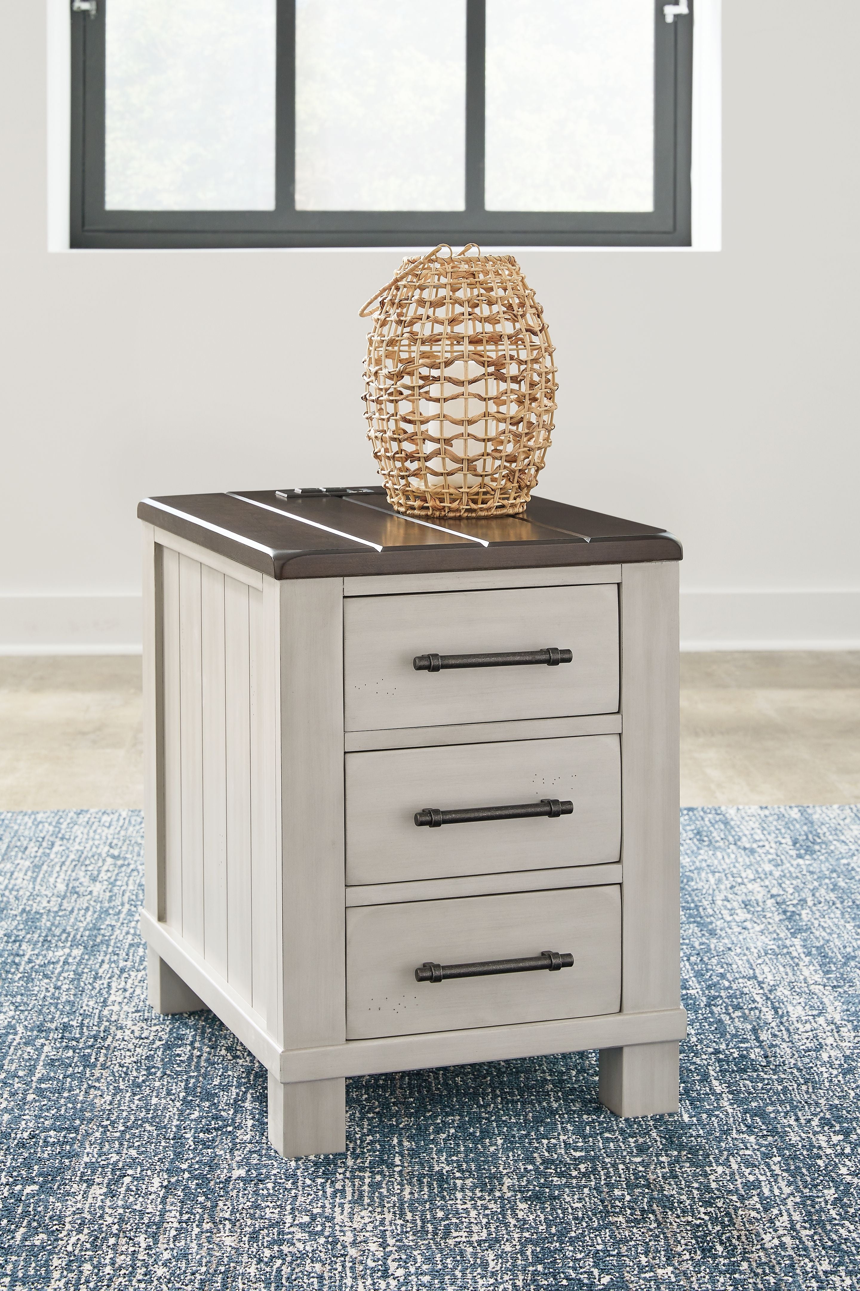 Chair side end table with dark brown slatted top and three stacked light gray drawer fronts