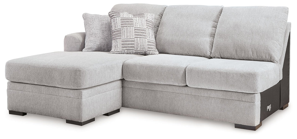 Light gray fabric sofa chaise with left chaise extension and two throw pillows