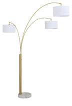Gold metal arc floor lamp with three white drum shades and round foot