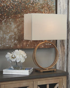 Antique gold metal table lamp with oval ring stand and beige fabric drum shade