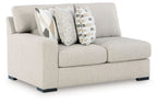 Light beige loveseat with rolled arms, two seat cushions, and decorative throw pillows.