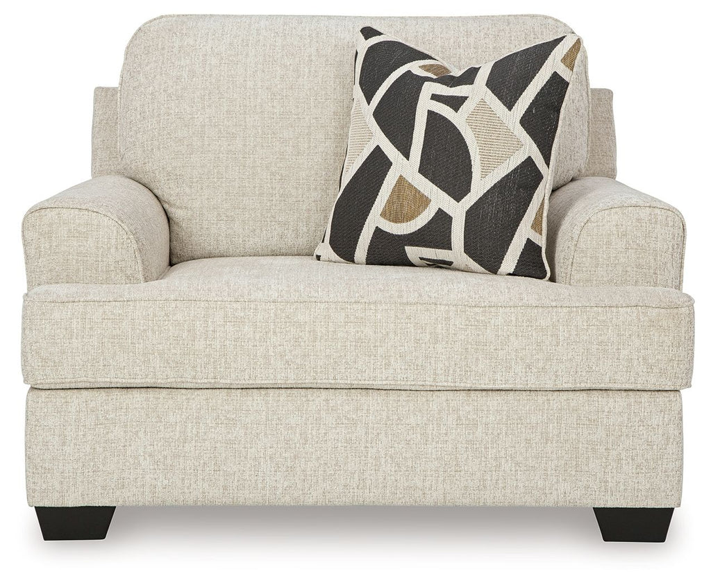 Quartz chair and a half armchair with light beige fabric and geometric black-and-tan pillow