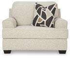 Quartz chair and a half armchair with light beige fabric and geometric black-and-tan pillow
