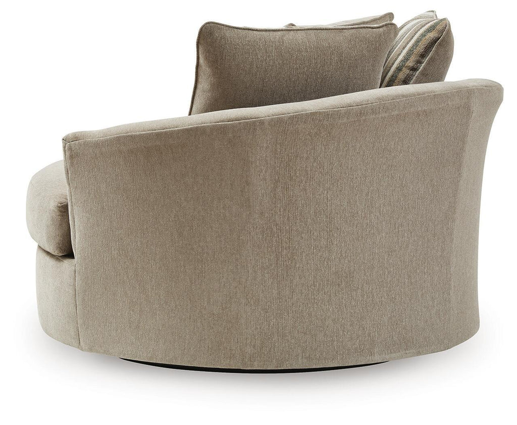 Oversized accent chair in beige fabric with rounded armrests and a high back cushion.