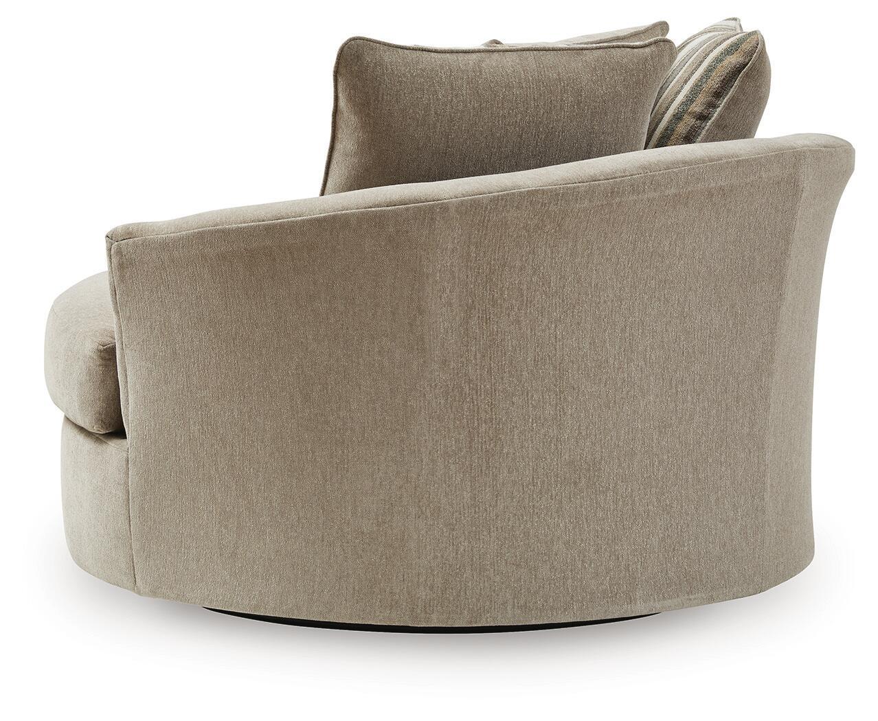 Oversized accent chair in beige fabric with rounded armrests and a high back cushion.