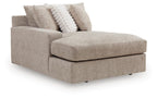 Gray upholstered chaise with thick seat cushion, boxed arms, and two decorative pillows