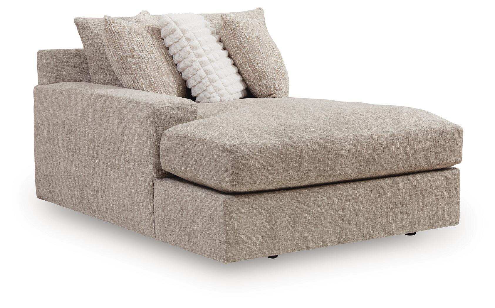 Gray upholstered chaise with thick seat cushion, boxed arms, and two decorative pillows