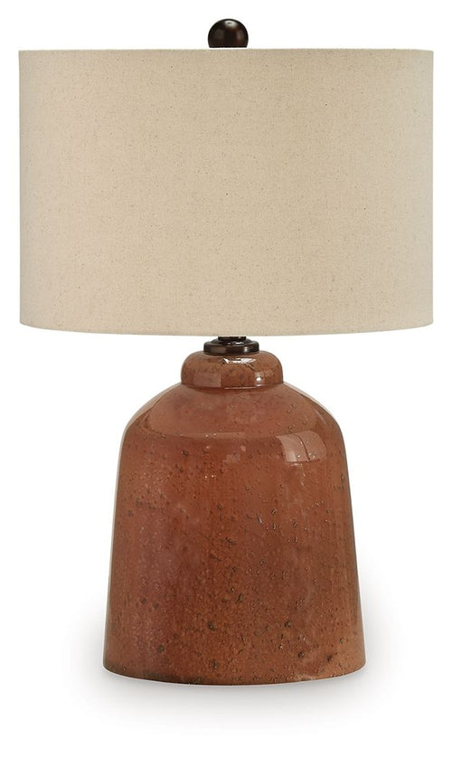 Rust glass table lamp with beige fabric shade and small finial