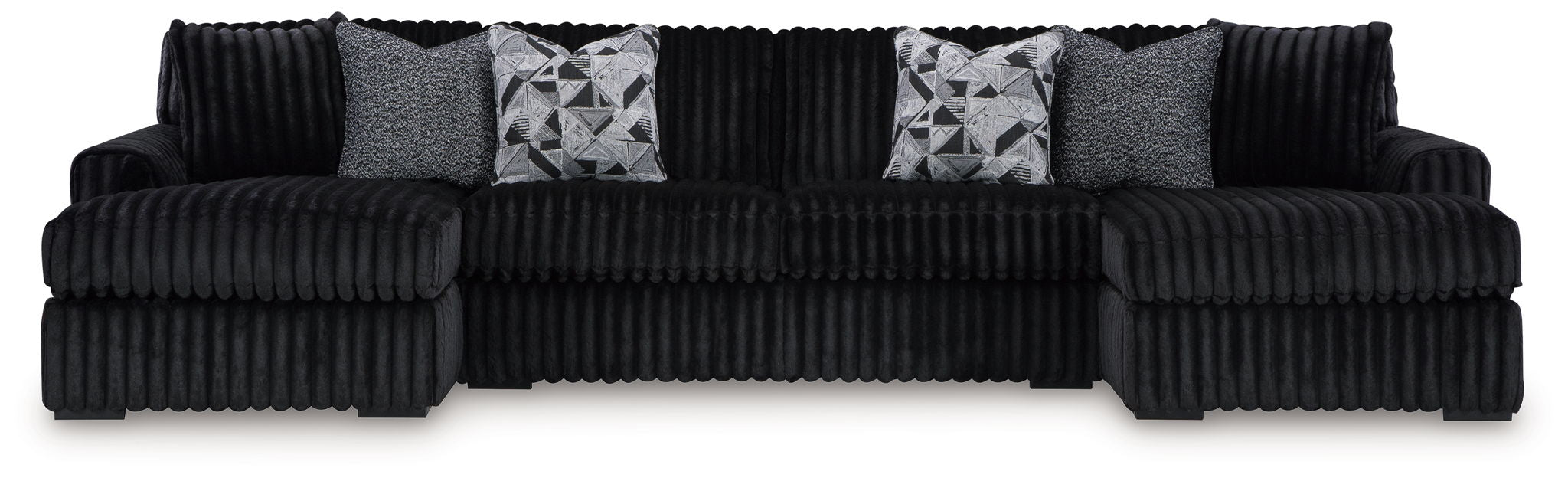 Black corded sectional sofa with chaise and gray patterned throw pillows