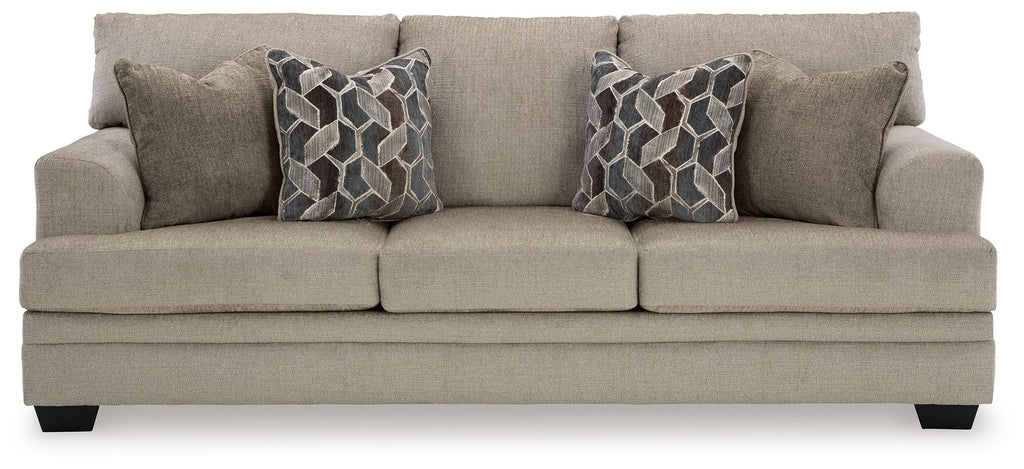 Stonemeade sofa in light taupe fabric with two geometric patterned throw pillows