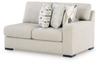 Pebble light-gray loveseat with armrests, black feet, and geometric patterned pillows