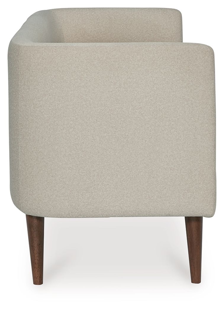 Beige upholstered accent bench side view with rounded arms and dark tapered legs