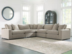 Light gray sectional sofa with chaise corner, square arms, and layered back cushions.