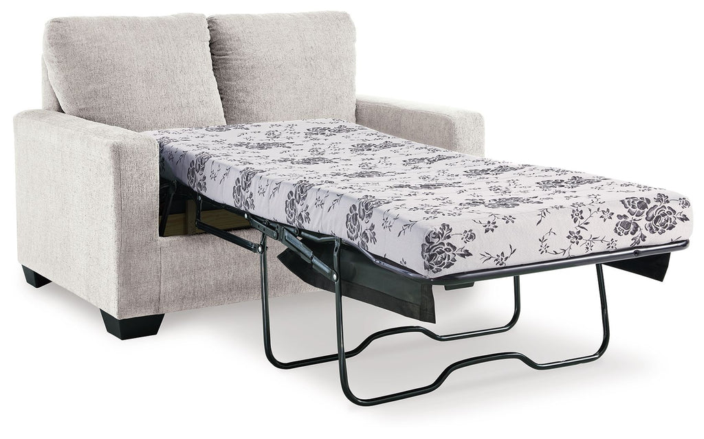 Light beige sofa bed with pulled-out mattress and floral patterned cover