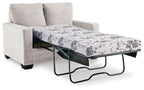 Light beige sofa bed with pulled-out mattress and floral patterned cover