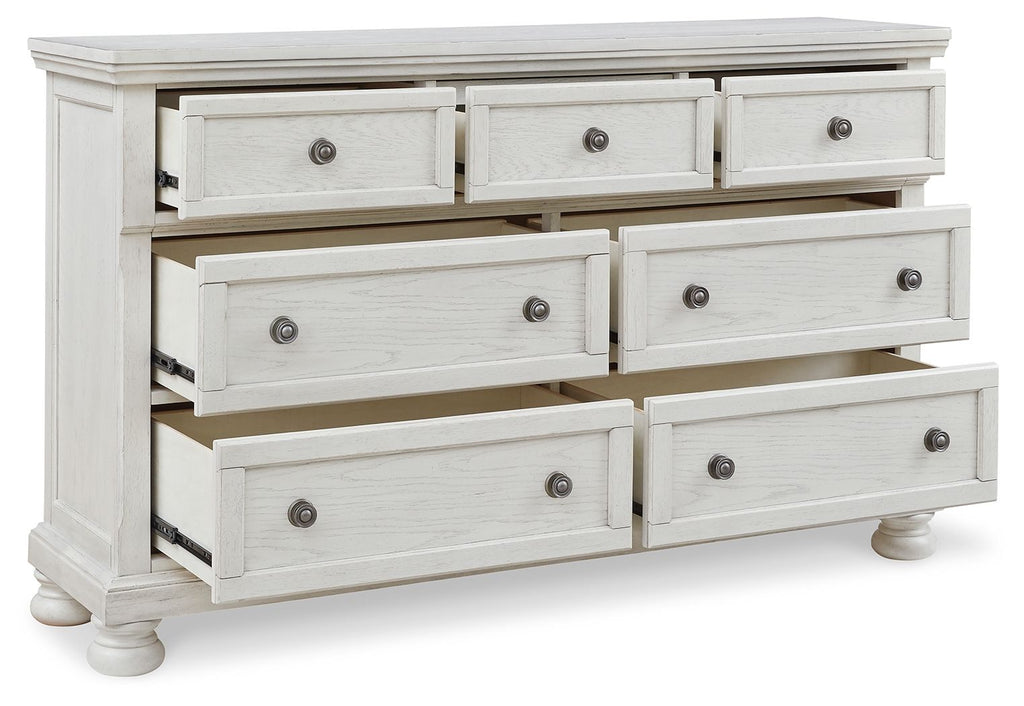 White dresser with multiple drawers and round knob hardware