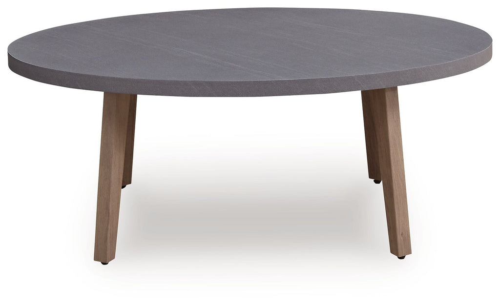 Oval gray cocktail table with four tapered legs, side view