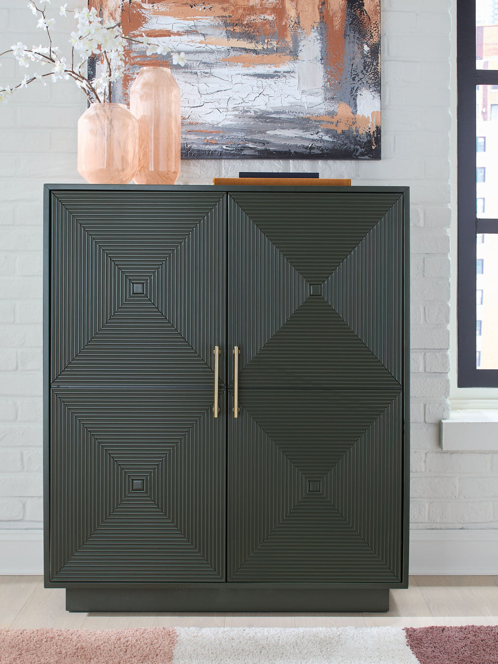 Dark green accent cabinet with geometric door panels and brass-tone double handles