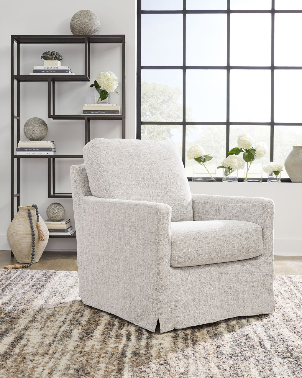 Light beige upholstered swivel glider accent chair with thick back cushion and arms