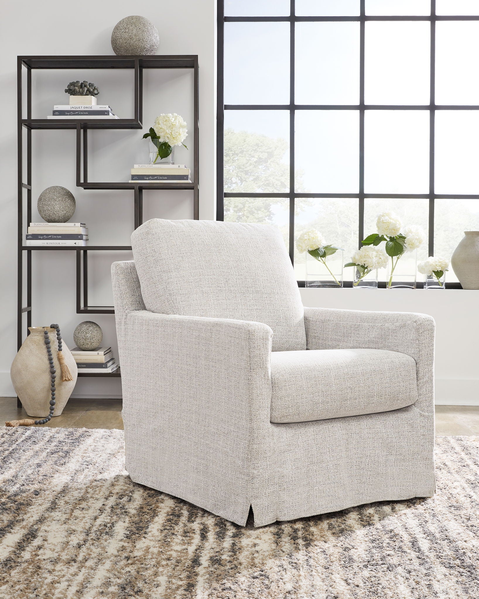 Light beige upholstered swivel glider accent chair with thick back cushion and arms