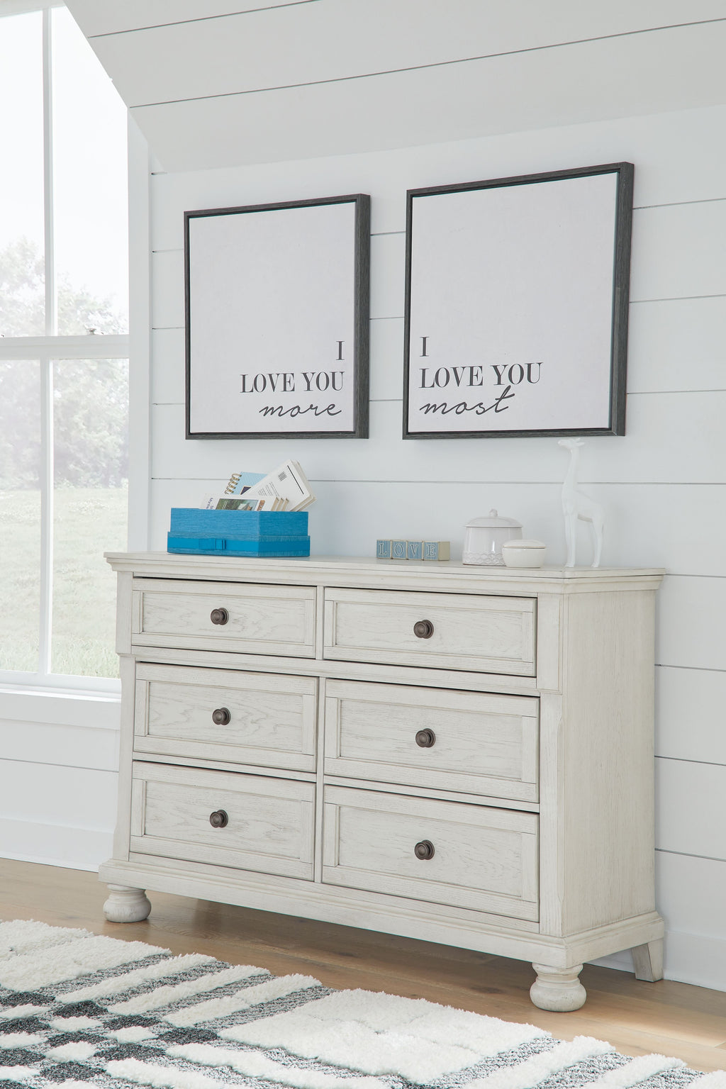 Antique white dresser with six drawers and round metal knobs, flat top surface.