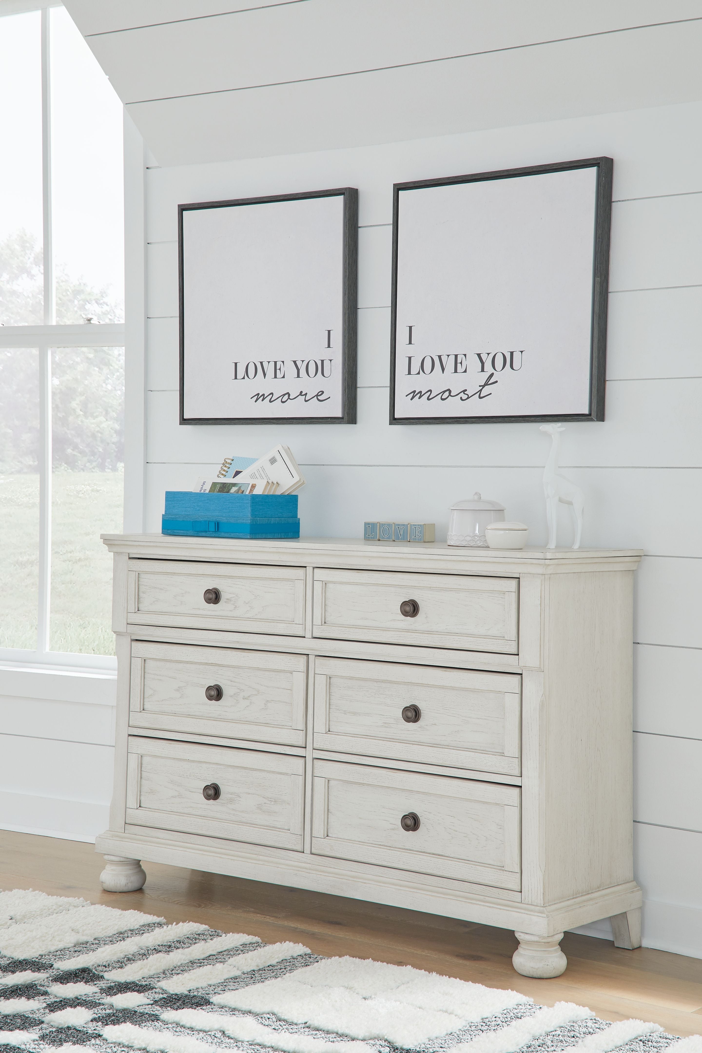 Antique white dresser with six drawers and round metal knobs, flat top surface.